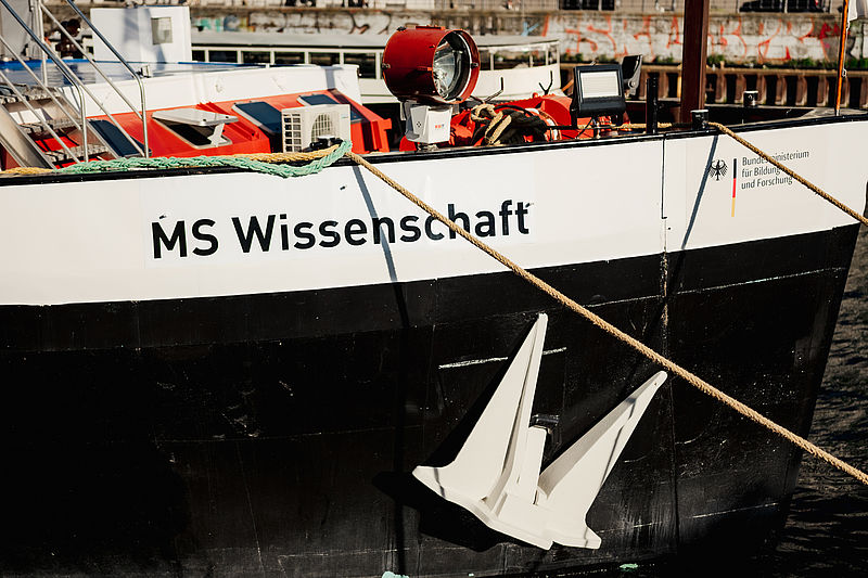 The bow of a white ship bearing the inscription &ldquo;MS Wissenschaft&rdquo;.